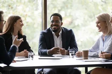 Five multiethnic company staff gather together talking planning future project