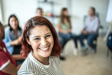 Woman smiling in therapy group
