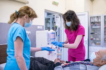 Nurses prepare patient for dialysis