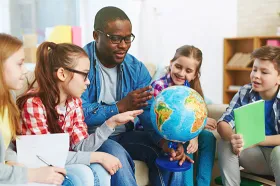 Teacher with students and globe