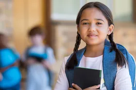 girl with backpack smiling