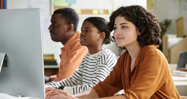 Young adults at a computer bank
