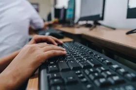 Hands at a computer keyboard
