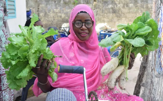 Kenyan woman holding crops