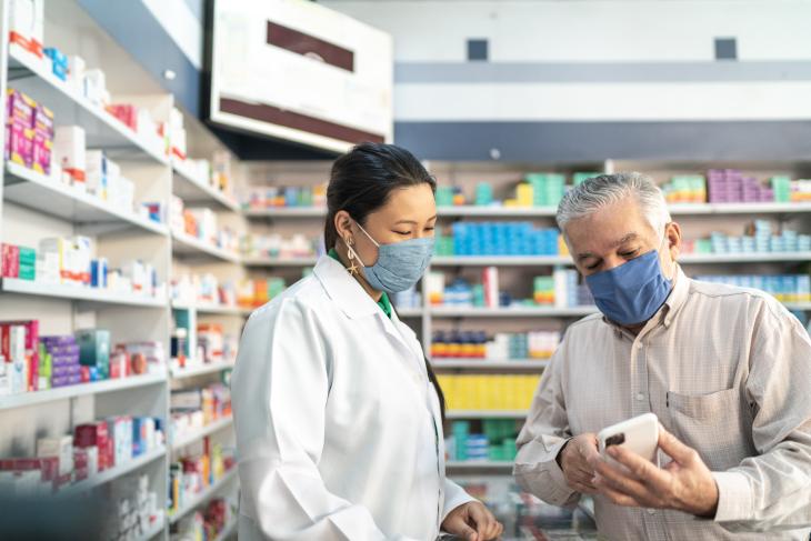 Female pharmacist helping a senior customer