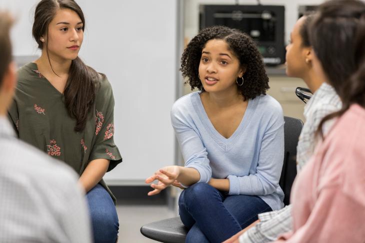 Teenage girl talks during support group meeting