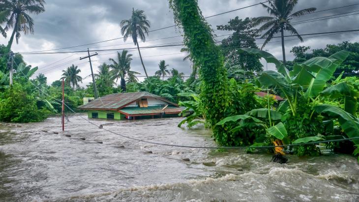 A rural home being submerged by floodwaters caused by torrential rain in the Philippines