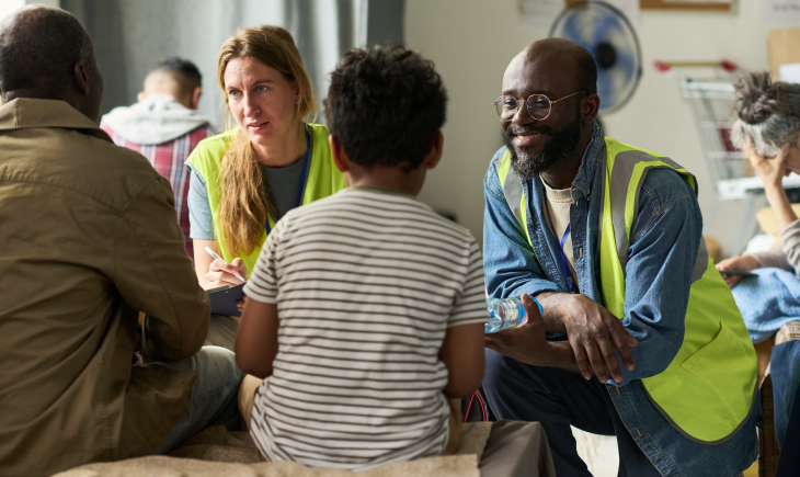 Volunteers Assisting Family during Community Relief Support Meeting