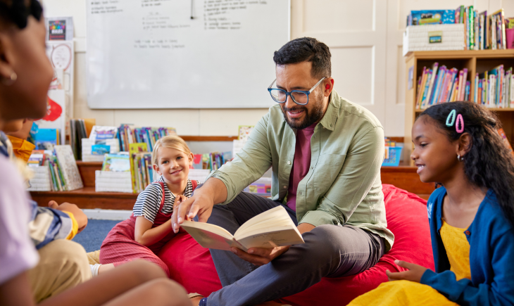 Librarian reading a novel book to multiethnic children