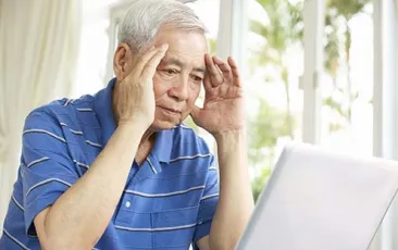 Image of confused older man at computer