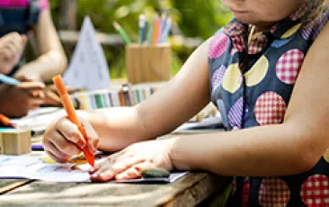 Image of girl drawing outside