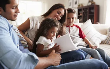 Image of Hispanic family reading together at home