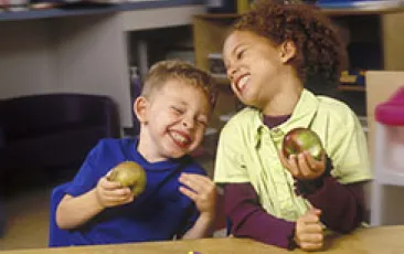 Preschool kids eating apples