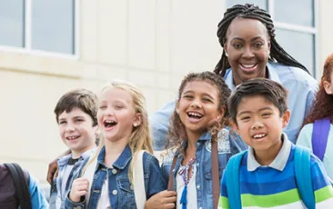 Image of school principal with students