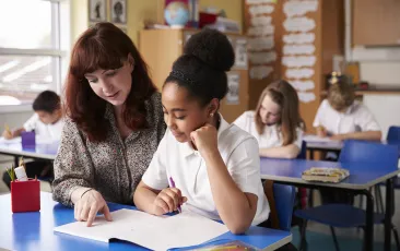 Teacher working closely with student