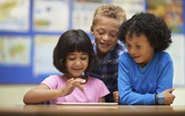 Three kids with an iPad