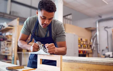 Image of apprentice using a sander
