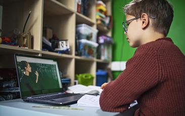 Image of boy distance learning on his laptop