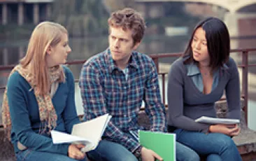 three college students in serious discussion