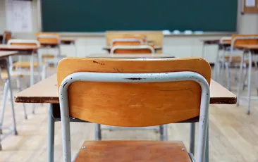 Image of empty desks in a classroom