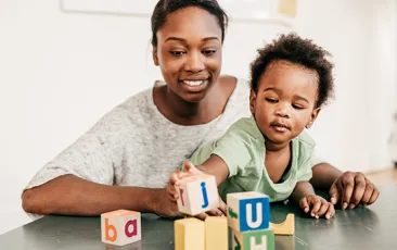 Image of mother and son playing with blocks