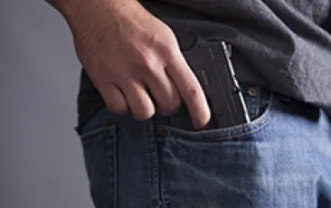 Man with gun in pocket
