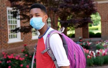 student-with-mask-and-backpack