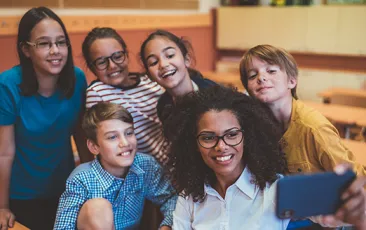 Teacher taking selfie with students