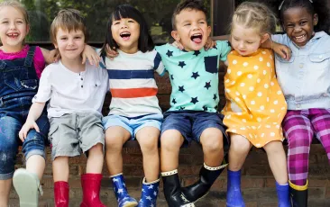 Children arm in arm singing