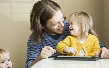 Man holding daughter with Downs syndrome