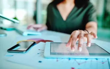 Woman typing on tablet
