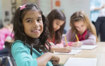 Female student working with friends in classroom