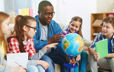 Teacher with students and globe