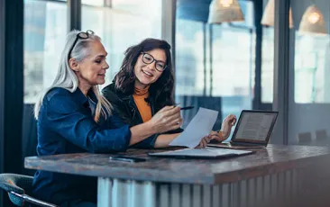 Two women analyzing work together