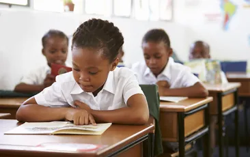 African child reading in a classroom