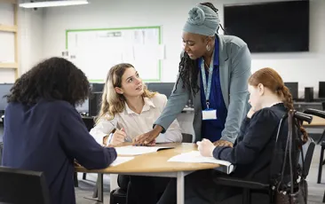 Teacher with high school students in classroom