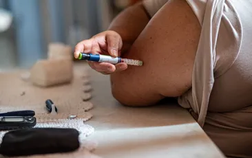 Woman injecting herself with insulin