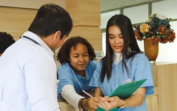 Healthcare trainee with coworkers