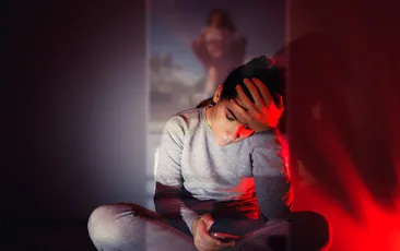 Sad teen on her phone