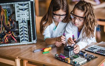 Two young girls working on a STEM project