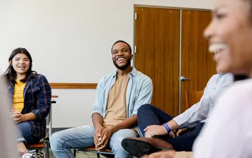 Smiling young people in a therapy group