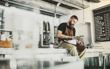 Bearded barista deep in thought
