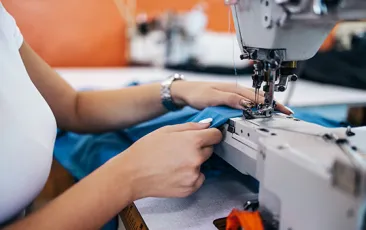 Woman's hands working at a sewing machine
