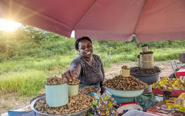 African woman selling peanuts in outdoor market