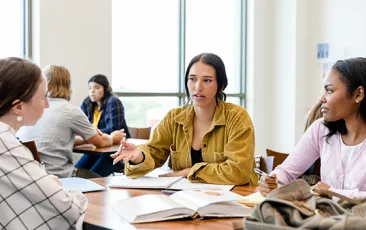 Students at table with notebooks