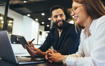 Happy entrepreneurs having a discussion in an office