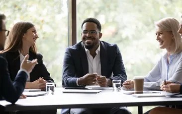 Five multiethnic company staff gather together talking planning future project