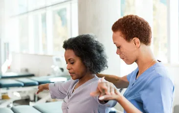 Woman working with her physical therapist
