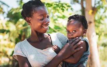 African mother holding her toddler
