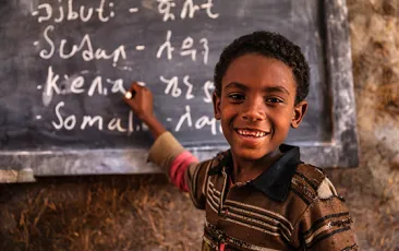 African young boy is learning Amharic language